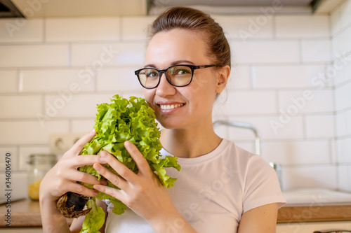 Happy woman girl 33-35 years old in the kitchen. Eating The concept of proper nutrition and healthy eating.