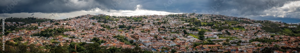 Aerial view panorama with sunshine over the historic town center and dramatic dark clouds in the sky, Diamantina, Minas Gerais, Brazil

