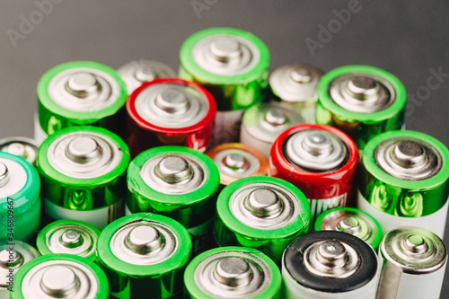 Closeup of group of used disposable batteries of various color.