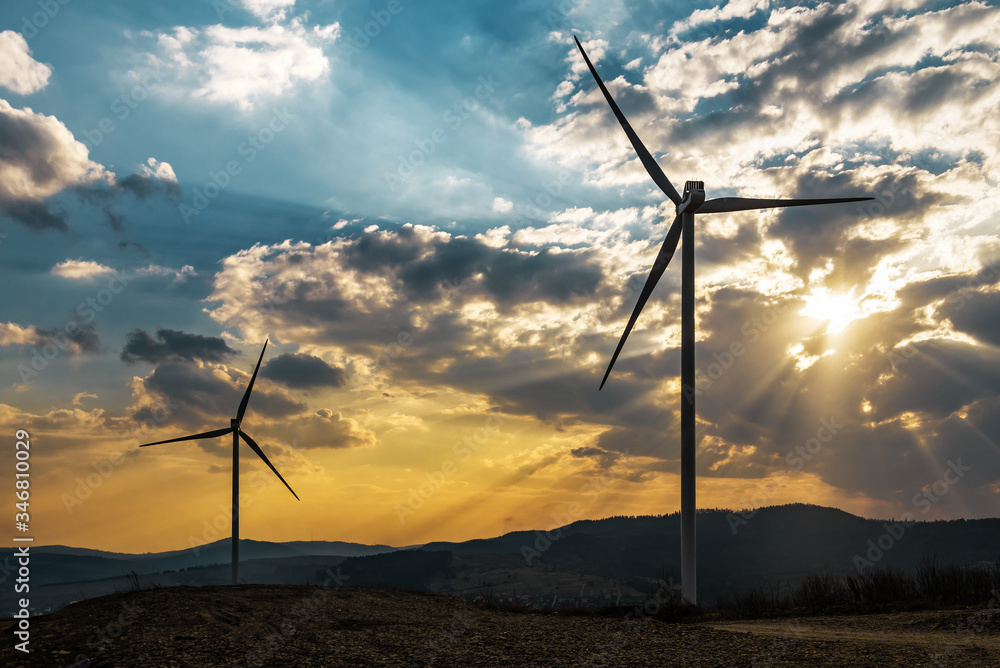 Obraz premium two windmills at sunset