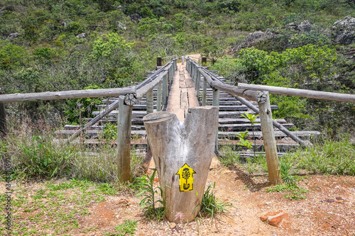 Wooden footbridge over a gorge in green vegetation, Biribiri State Park, Minas Gerais, Brazil
 photo