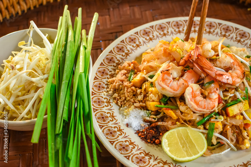 Photography Thai Stir-fried rice noodles (Pad Thai) with shrimp and vegetables