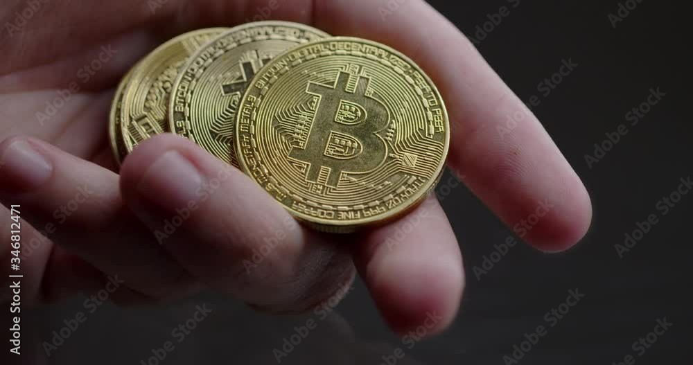 hand full of coins showing a bitcoin hand full of coins showing a bitcoin