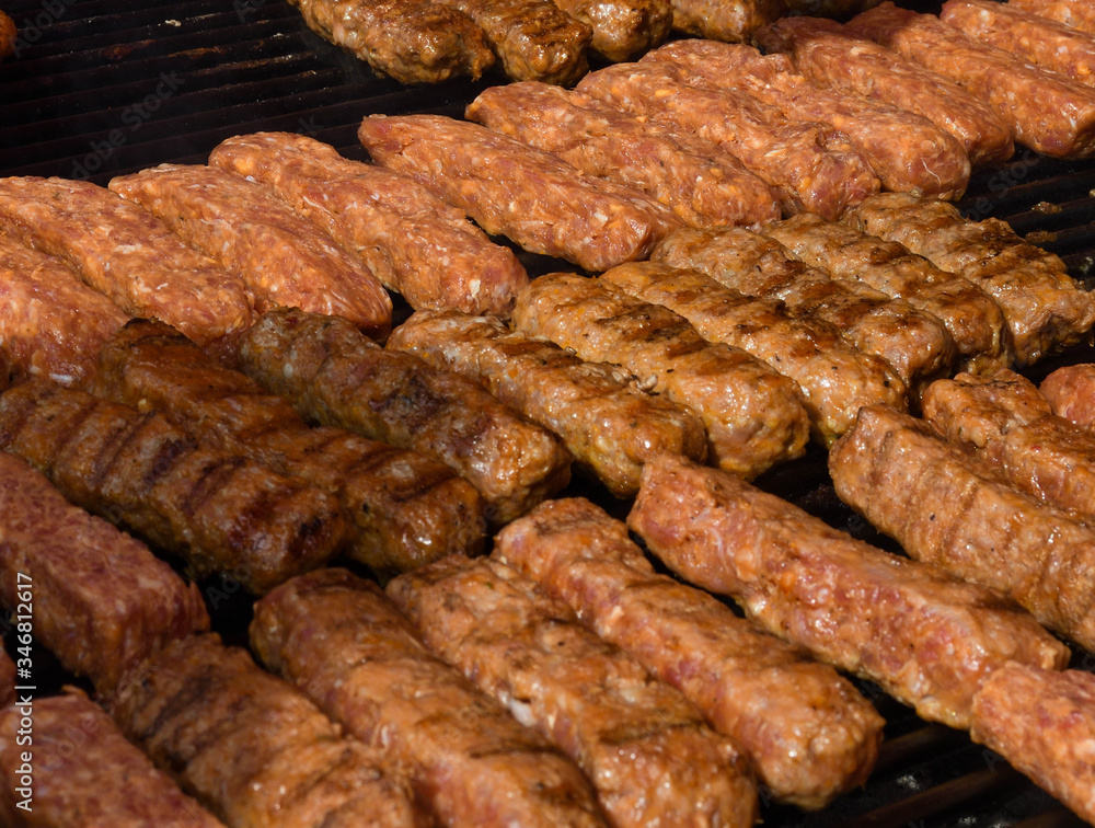 Chef grilling meat during cookout picnic or food event. Meat mix variety, Labour Day, 1 Mai Chef grilling meat during cookout picnic or food event. Meat mix variety, Labour Day, 1 Mai