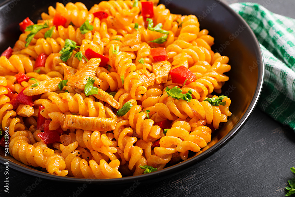 Fusilli pasta with chicken and sweet pepper in tomato sauce. Italian Cuisine. Fusilli pasta with chicken and sweet pepper in tomato sauce. Italian Cuisine.