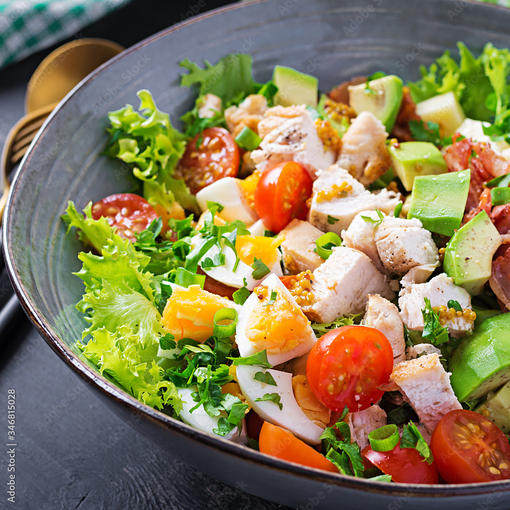 Healthy cobb salad with chicken, avocado, bacon, tomato, cheese and eggs. American food. Healthy cobb salad with chicken, avocado, bacon, tomato, cheese and eggs. American food.