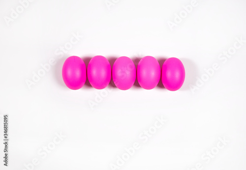 Pink eggs on white background