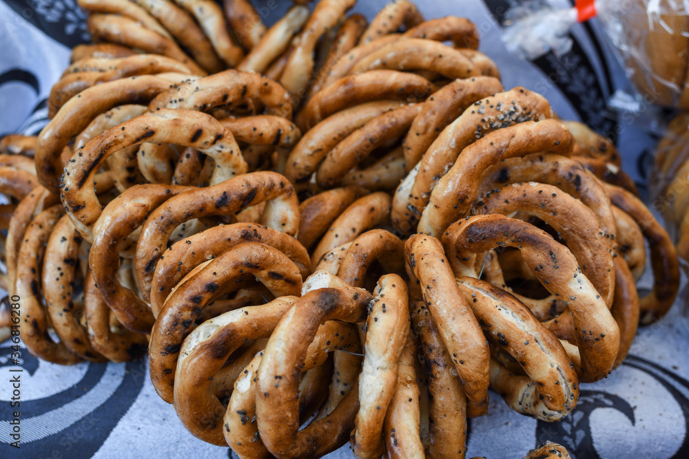 German pretzels stack one over each other, group of thin dry pretzels on rope German pretzels stack one over each other, group of thin dry pretzels on rope