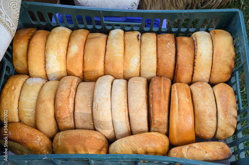 A variety of wheels of cheese seasoned with herbs for sale at the deli counter in the supermarket. photo