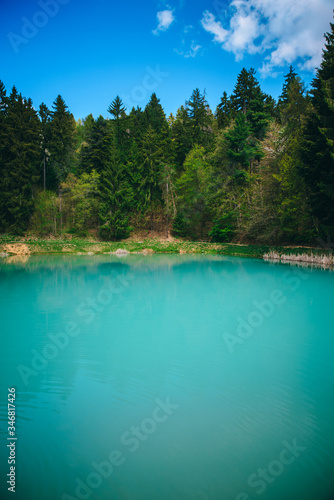 Blue lake in green nature, wonderland in spring time