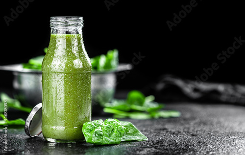 Freshly made spinach smoothie (close up; selective focus)