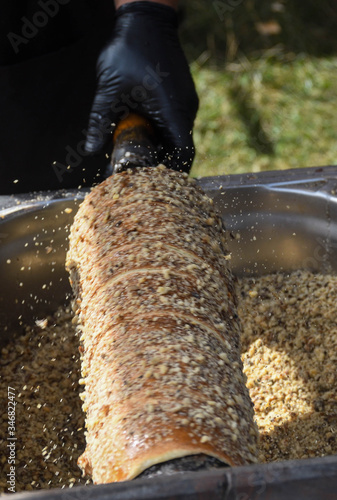 Kurtos kalacs or chimney cakes, preparing on charcoal grill, street food traditional Hungarian photo