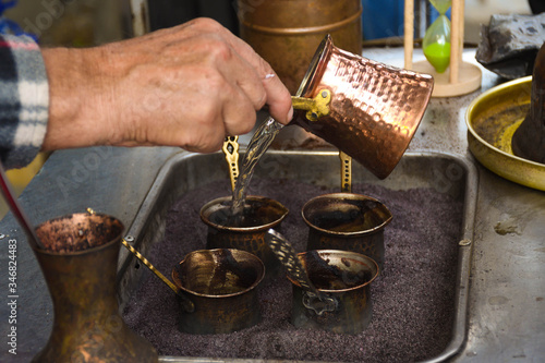 Turkish coffee reparation during street food festival, traditional specialty drink served
