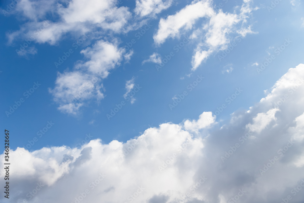Scenic sky background. Blue sky with fluffy white clouds Scenic sky background. Blue sky with fluffy white clouds