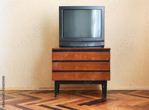 Vintage Television on wooden antique closet, old design in a home