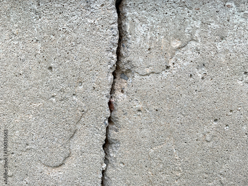 Close up photo of a crack in a concrete foundation. Structural repair and construction.