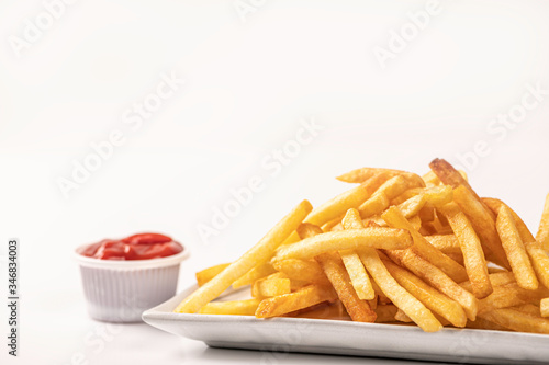 French fries with ketchup isolated on white background.