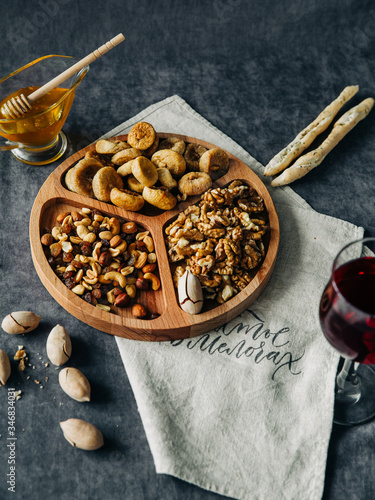 menazhnitsa with nuts dried fruits and honey on a dark background photo