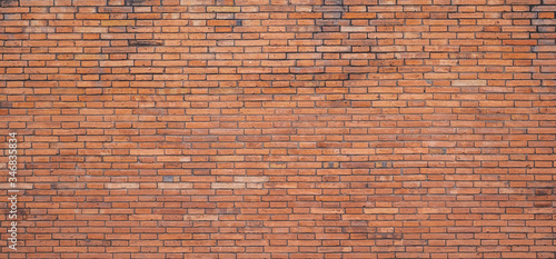 The background of the brick wall with dark orange is beautifully arranged. Ancient wall Grunge background The backdrop may be used in interior design.