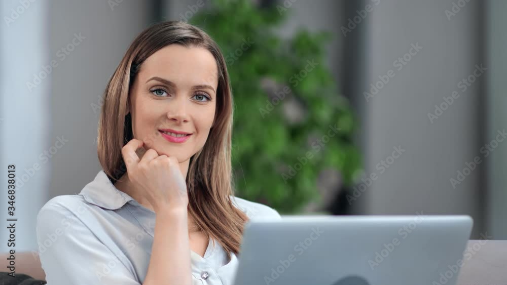 Portrait smiling business woman posing in front of laptop pc. Medium close up shot on 4k RED camera Portrait smiling business woman posing in front of laptop pc. Medium close up shot on 4k RED camera