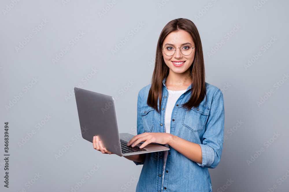 Portrait of positive cheerful clever intelligent ceo expert girl work laptop ready decide work solution wear stylish denim clothes isolated over gray color background Portrait of positive cheerful clever intelligent ceo expert girl work laptop ready decide work solution wear stylish denim clothes isolated over gray color background