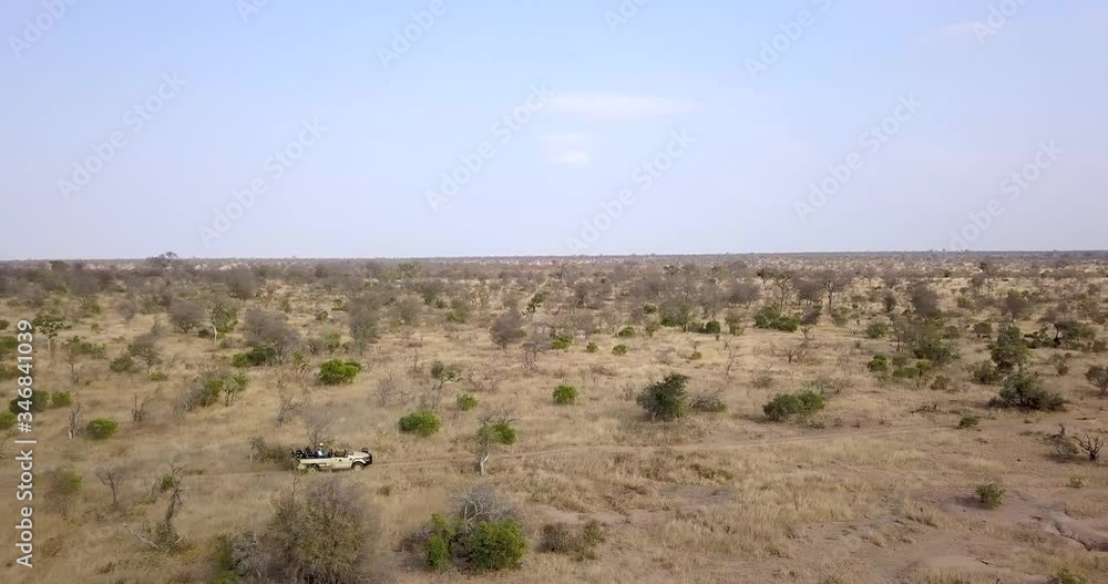 Drone follows an african safari vehicle in a game reserve in Africa Drone follows an african safari vehicle in a game reserve in Africa