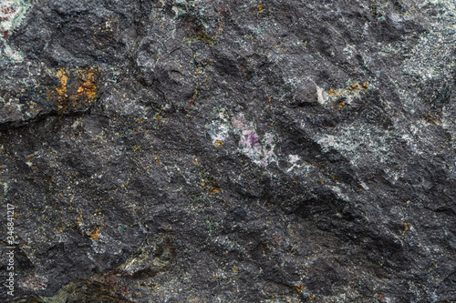 Magnetite iron ore texture close-up. Contains magnetit, pyrite, calcite, magnesioferrite, spinel, fluorite. Siberian natural resources deposit. Mineral stone surface background.