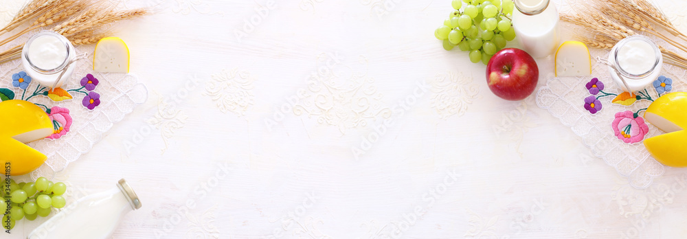 Top view photo of dairy products over white background. Symbols of jewish holiday - Shavuot