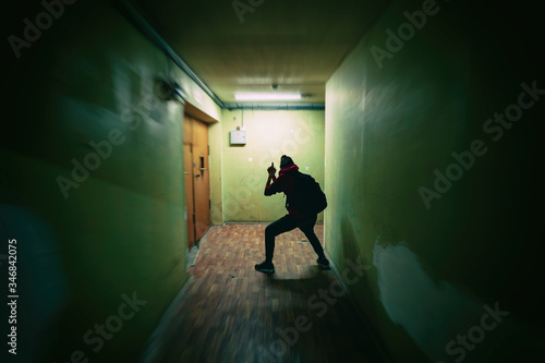 Photos Girl silhouette imitates playing a spy with a gun