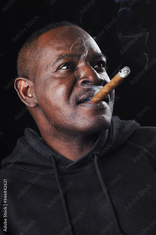 Portrait of a black man with a cigar. Portrait of a black man with a cigar.