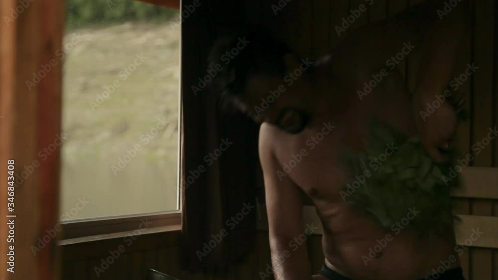 a man steams in the bath with a broom. The concept of a healthy lifestyle, a strong body, hardening, hygiene, elimination of toxins from the body, environmental friendliness a man steams in the bath with a broom. The concept of a healthy lifestyle, a strong body, hardening, hygiene, elimination of toxins from the body, environmental friendliness