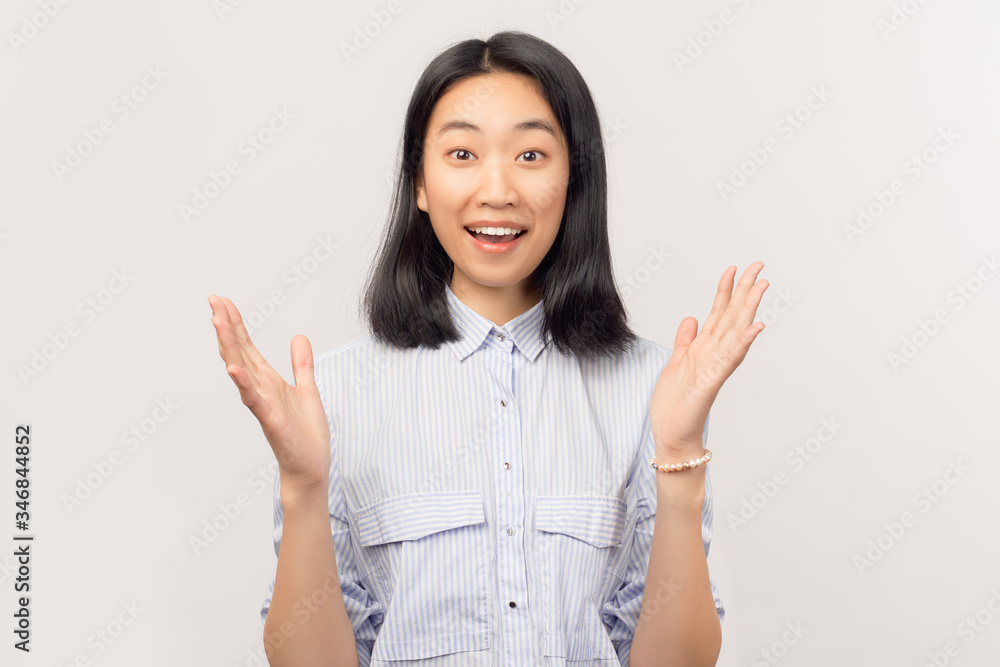 An emotionally attractive girl looks admiringly at camera, is happy with presentation of new equipment, keeps jaw hanging and eyes wide open, admires speed and comfort, has an enthusiastic attention An emotionally attractive girl looks admiringly at camera, is happy with presentation of new equipment, keeps jaw hanging and eyes wide open, admires speed and comfort, has an enthusiastic attention