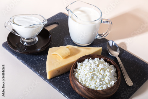 Food is a source of calcium, magnesium, protein, fats, carbohydrates, balanced diet. Dairy products on the table: cottage cheese, sour cream, milk, cheese, contain casein, albumin, globulin, lactose