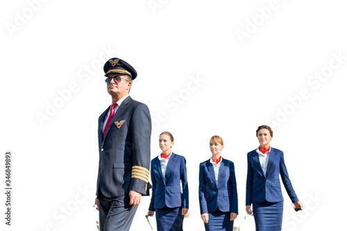Cutouts of mature pilot walking with three young beautiful stewardess