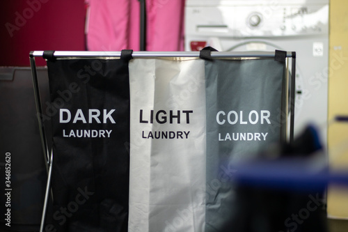 Laundry sorting basket with dark, light, and color laundry.
