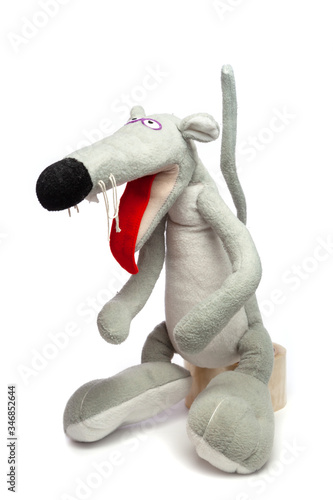 Soft toy of gray rat stands on white background