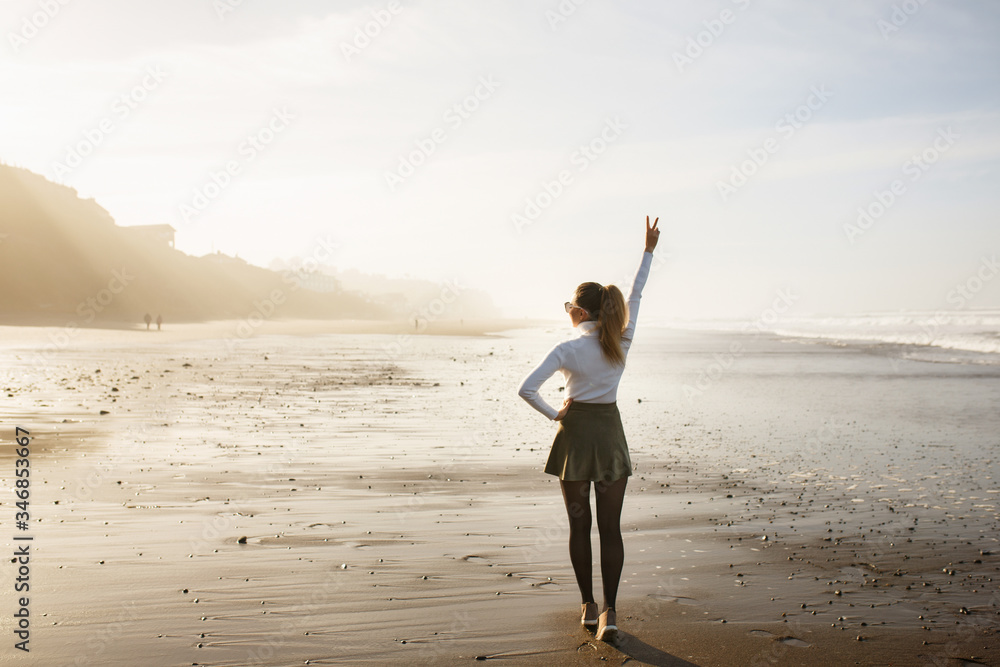 woman enjoying a walk on the beach woman enjoying a walk on the beach