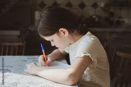 A teenager girl draws a pen in a sketchbook. Idea for quarantining a child