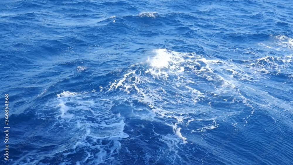 The Blue Water is Around the Yacht. Ocean Waves Are Rising Towards the Deck. White Foam Appears From Collision of Waves With the Ships Deck. The Blue Water is Around the Yacht. Ocean Waves Are Rising Towards the Deck. White Foam Appears From Collision of Waves With the Ships Deck.