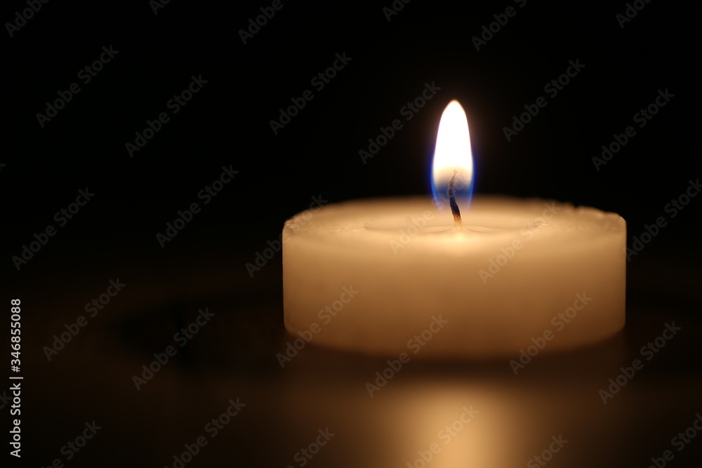 Selective focus close-up of memorial candle on black background Selective focus close-up of memorial candle on black background
