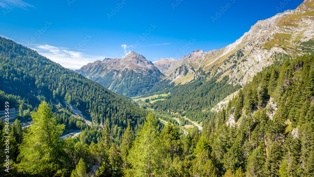 Looking into the valley Val Bregaglia (German: Bergell) when standing on top of the Maloja Pass (Engadin, Switzerland), a high mountain pass in the Swiss Alps in the canton of Graubünden Looking into the valley Val Bregaglia (German: Bergell) when standing on top of the Maloja Pass (Engadin, Switzerland), a high mountain pass in the Swiss Alps in the canton of Graubünden