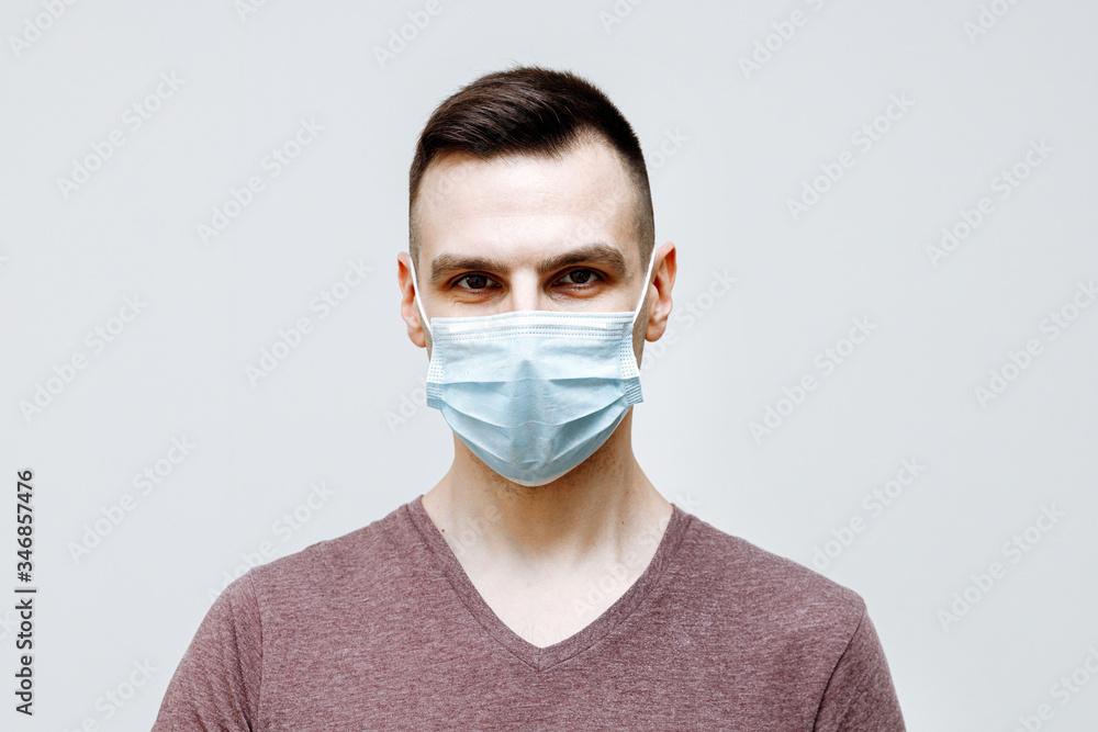 Protection from infectious diseases, coronavirus. A person wears a hygiene mask to prevent flu or cold infection. closed Studio shot on a white background
Protection from infectious diseases, coronavirus. A person wears a hygiene mask to prevent flu or cold infection. closed Studio shot on a white background