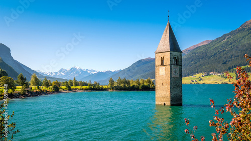 Lake Resia (Reschensee) and Ortler Mountains in Val Venosta (Alto Adige, Italy). It is famous for the tower of a 14th-century church of village Graun that submerged when the lake was deepened in 1950