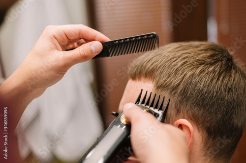 Close-up view of man getting a haircut