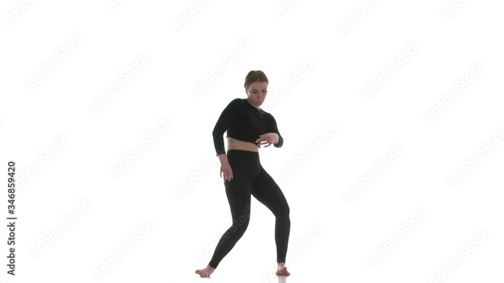 young beautiful woman dancer in black short top and black leggings emotionally dancing contemporary, modern ballet dance, isolated, slow motion young beautiful woman dancer in black short top and black leggings emotionally dancing contemporary, modern ballet dance, isolated, slow motion