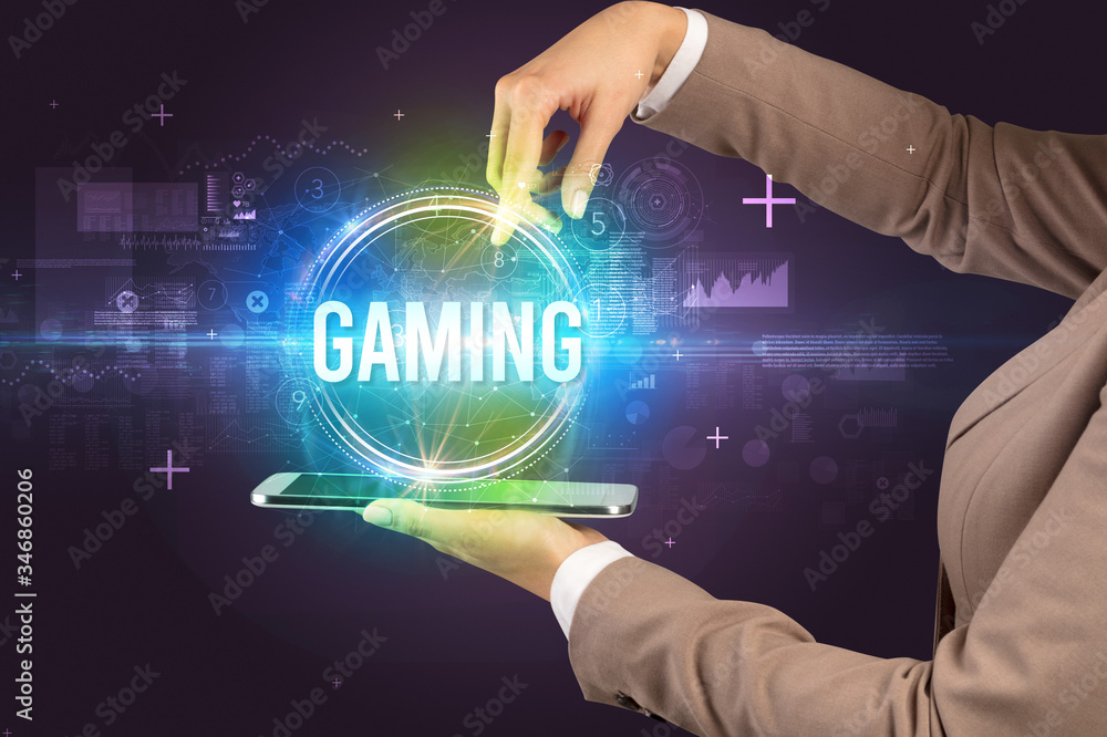 Close-up of a touchscreen with GAMING inscription, new technology concept Close-up of a touchscreen with GAMING inscription, new technology concept