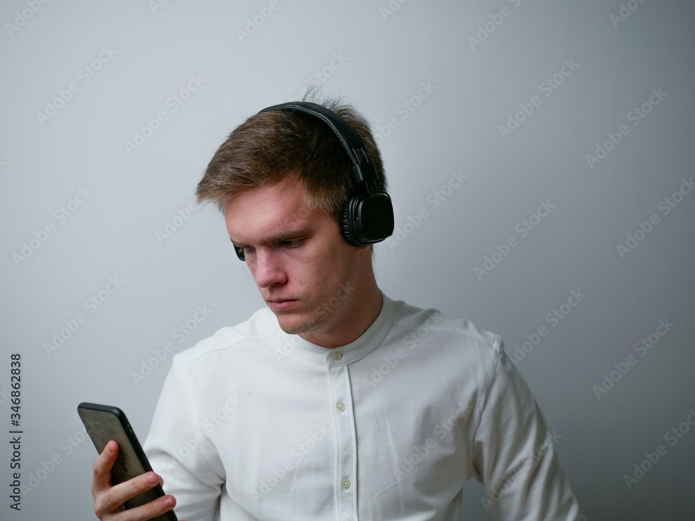 Close-up portrait of young man wearing white shirt listening pop rock stereo sound soul jazz spending weekend isolated over white background. Close-up portrait of young man wearing white shirt listening pop rock stereo sound soul jazz spending weekend isolated over white background.