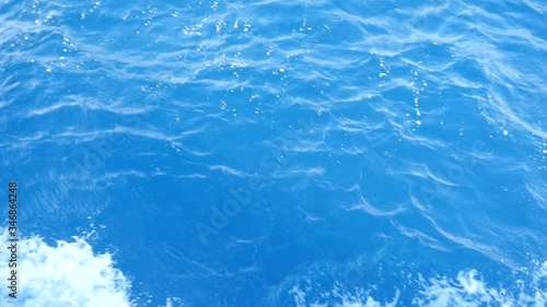 Cruise for Group of a Tourists on a Motor Boat in the Red Sea. The Day is Sunny but Gusty Wind Brings Water Splashes on the Deck. Waves Beat the Deck and Blue Water Splatters Flies in the Distance.