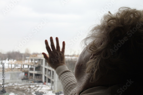 Fototapeta Naklejka Na Ścianę i Meble -  Elderly woman living her solitude and confinement