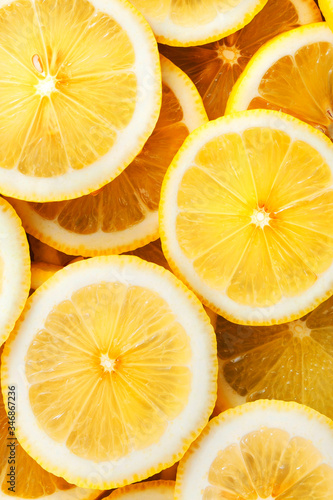 Sliced lemons. Background and texture. Vertical color photo.